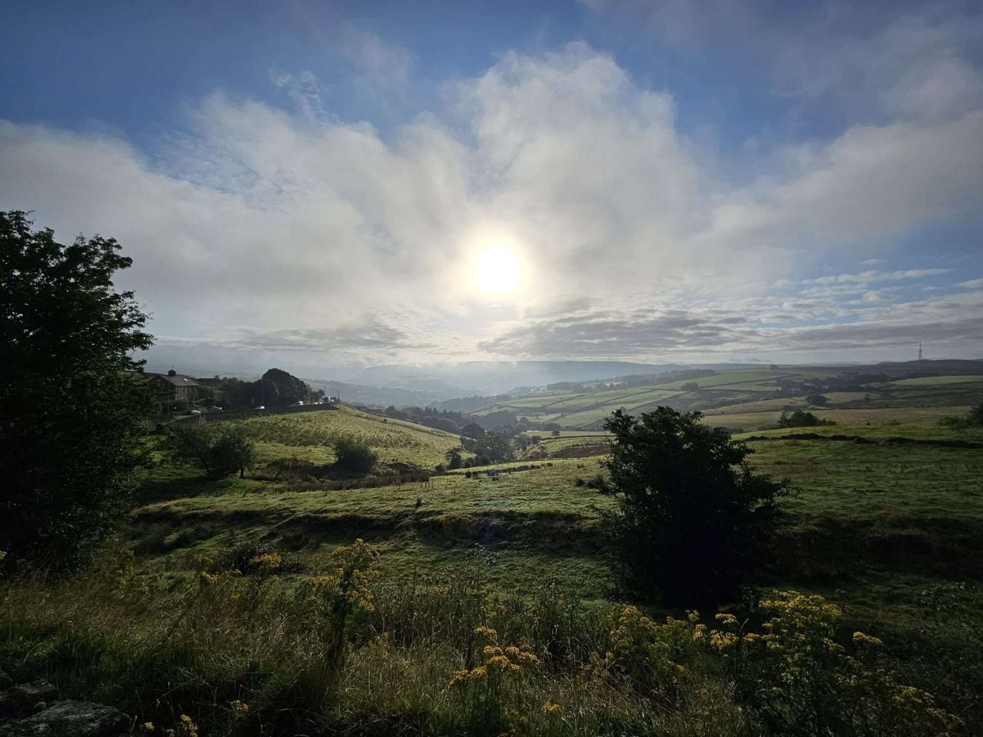 Morning sun over a green moorland valley in Saddleworth