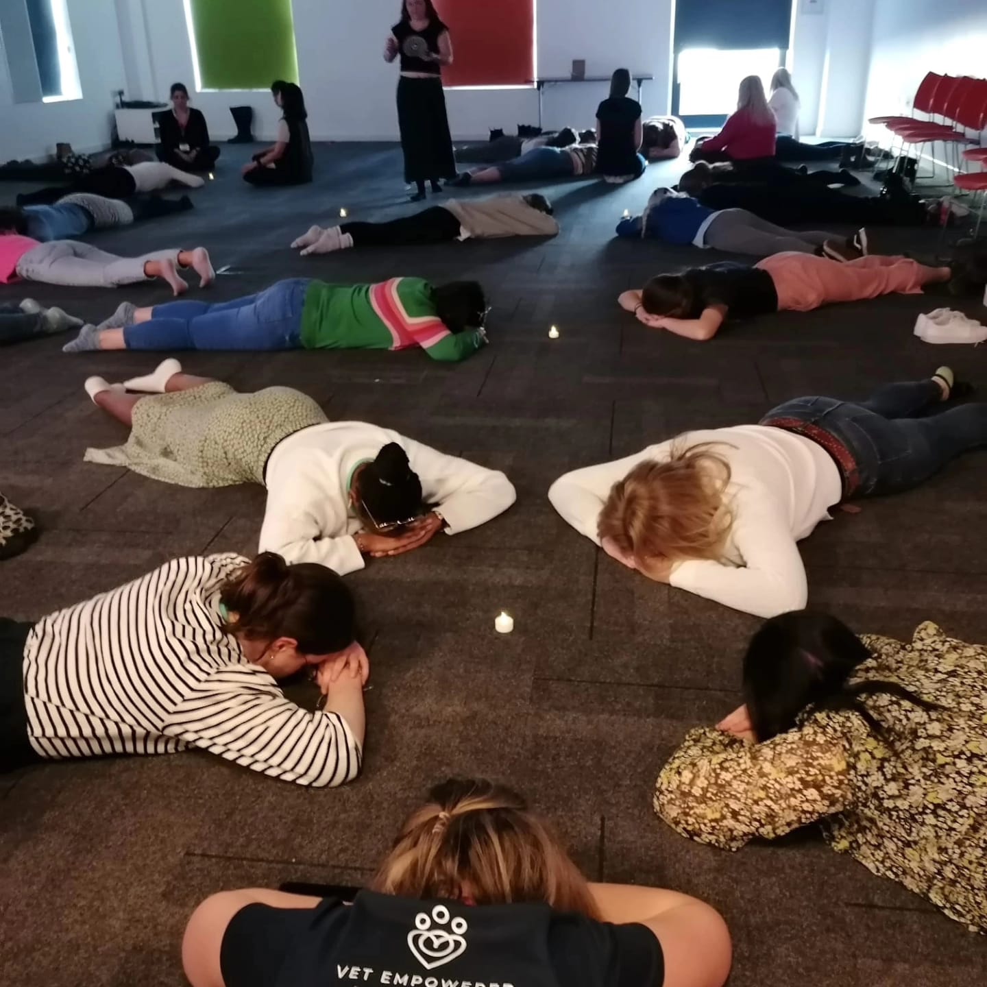 A group resting on the floor during a guided practice
