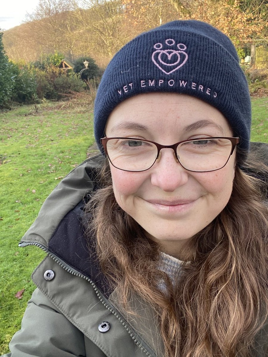 Beth Handley smiling outdoors in glasses and a navy Vet Empowered beanie.