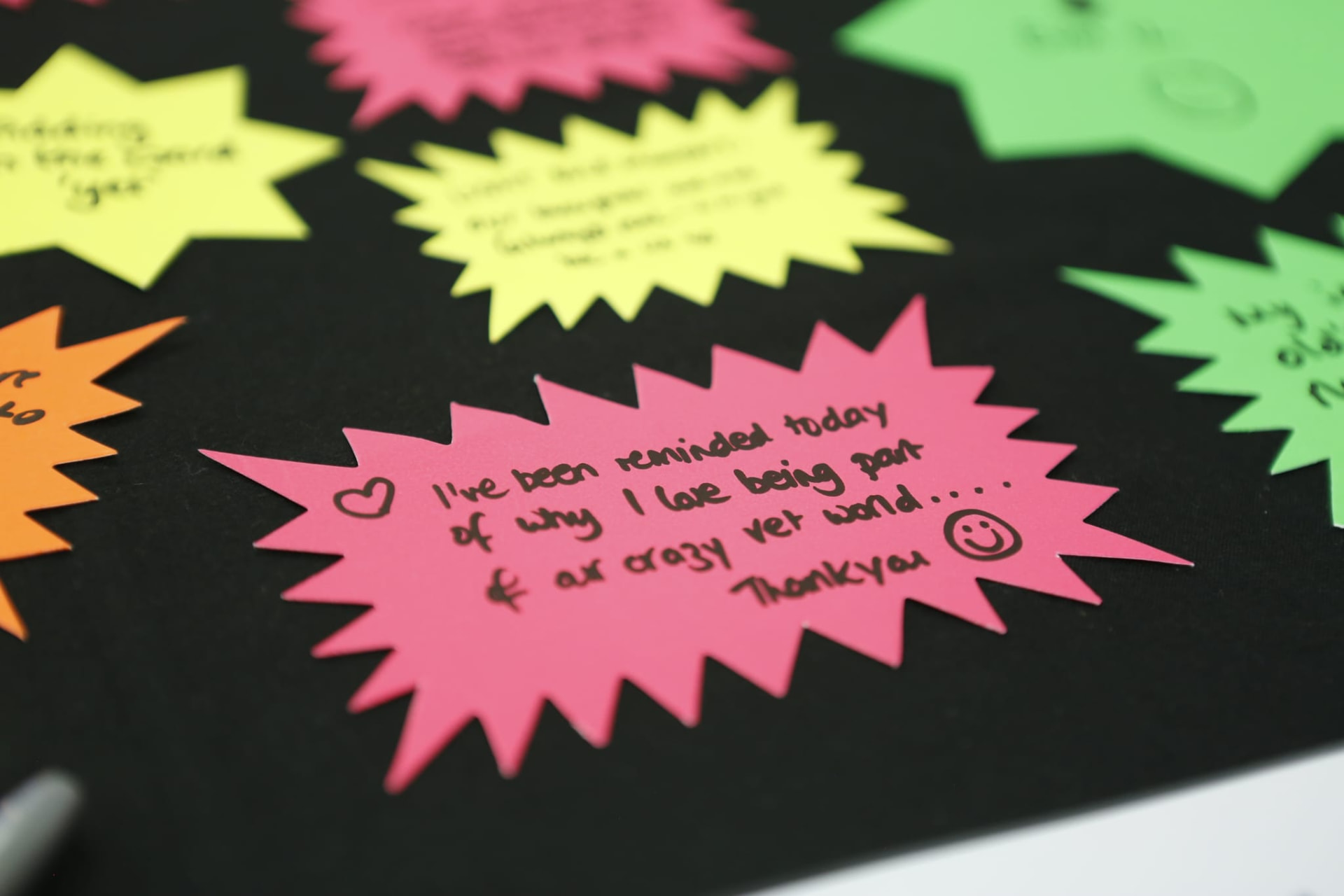 Handwritten notes from attendees on bright paper stars