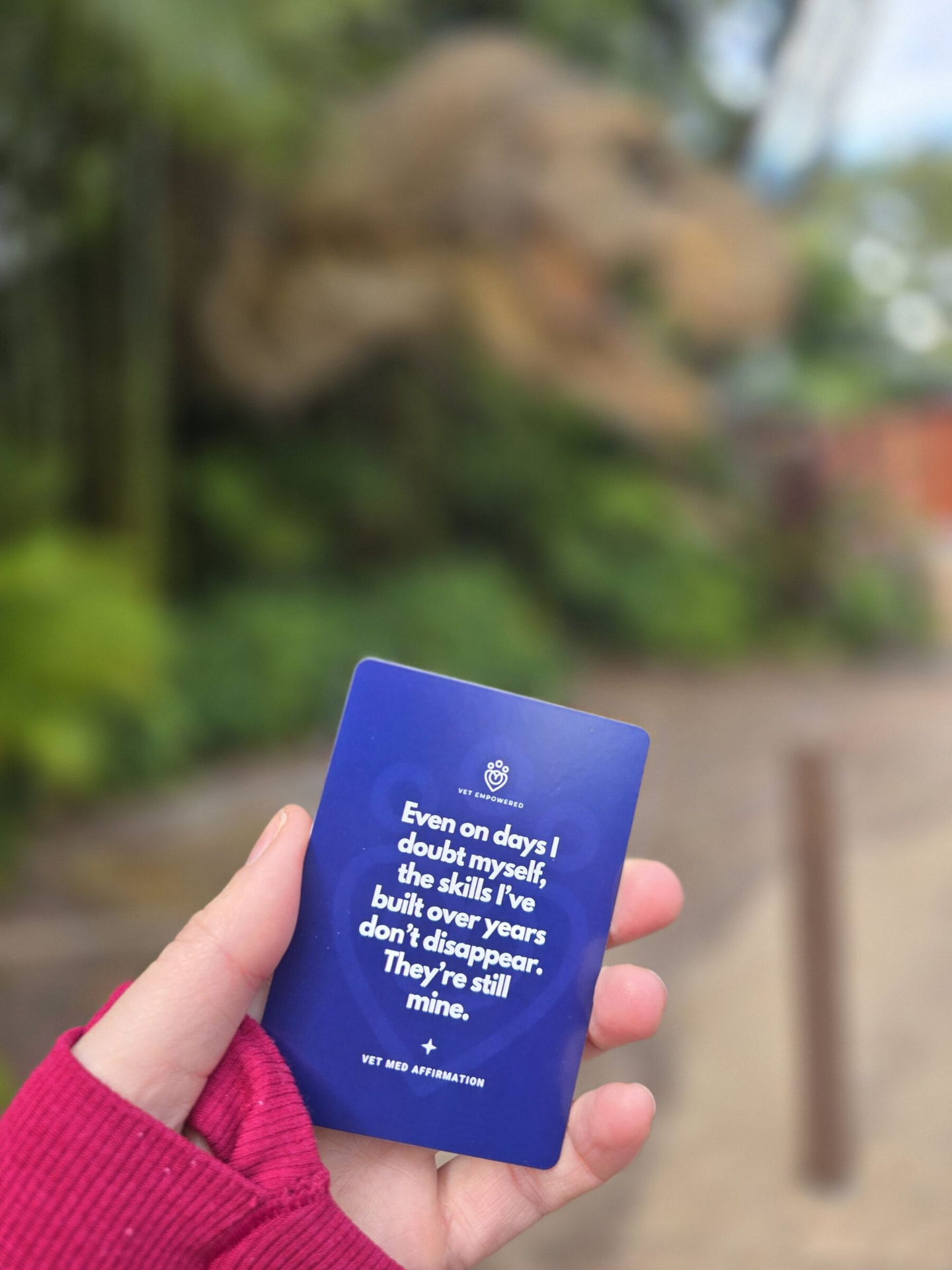 A hand holding a Vet Empowered affirmation card