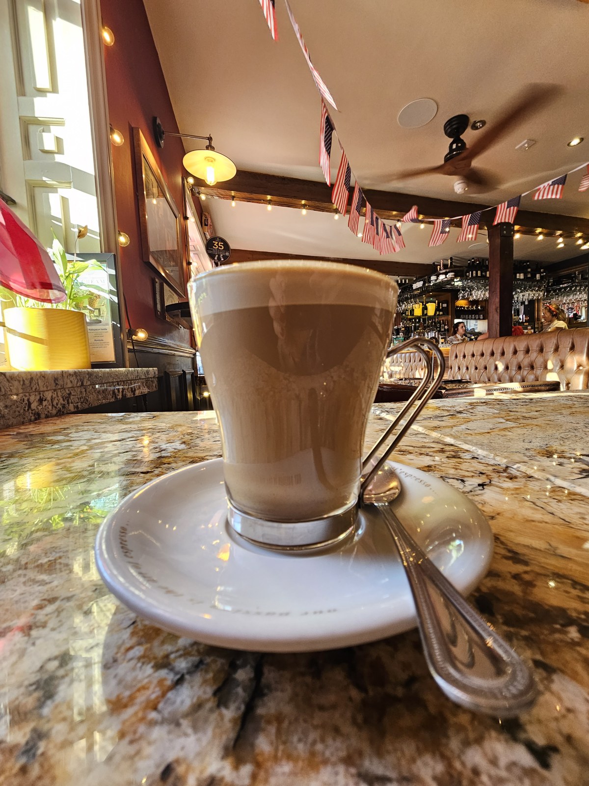 A latte in a glass on a café table