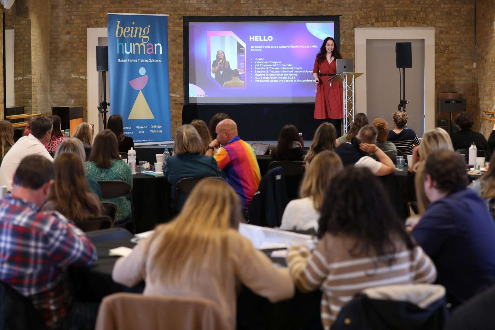 Katie speaking on stage at a Vet Empowered event