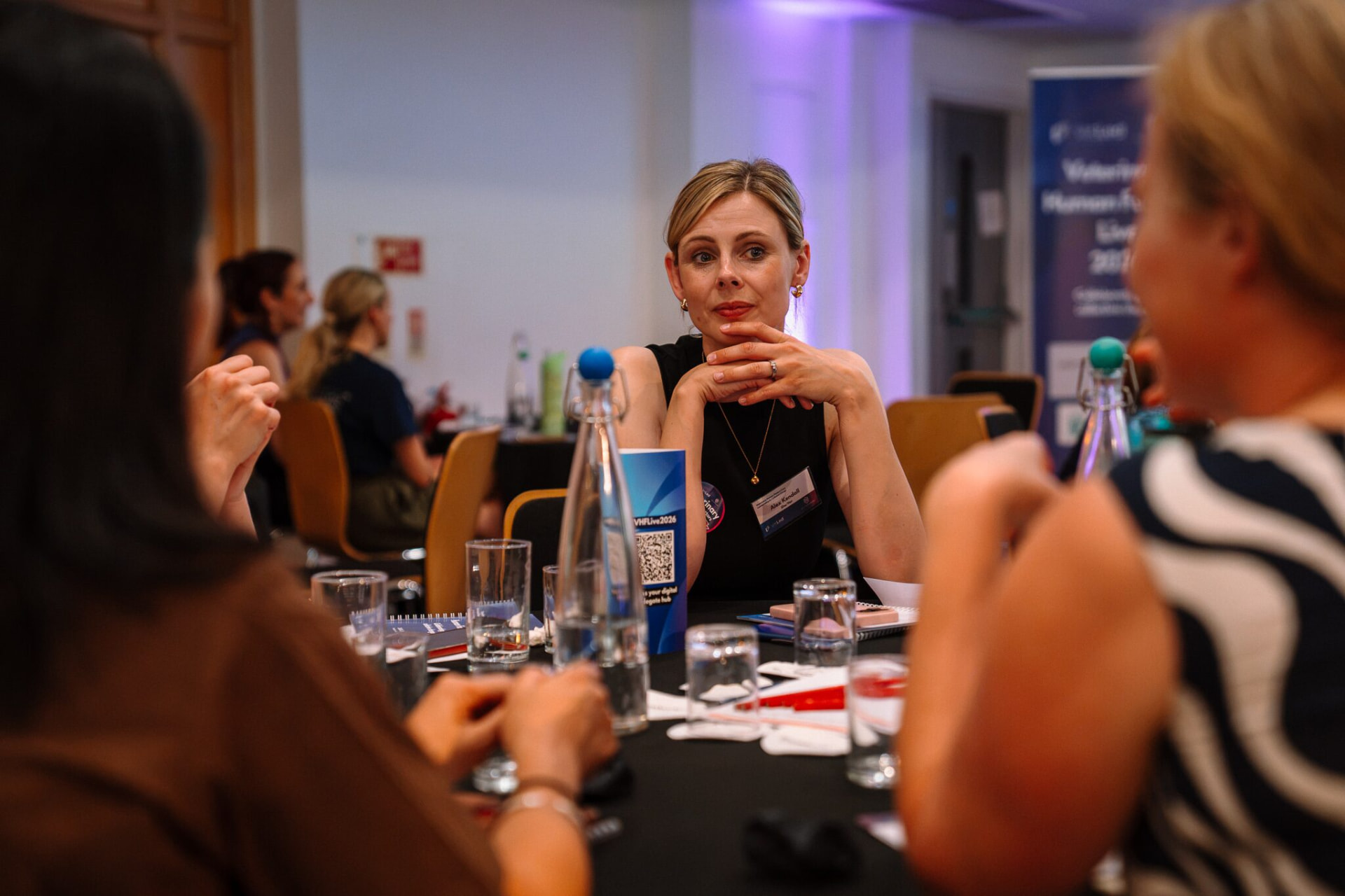 Alex Kendall listening intently at a table discussion at Veterinary Human Factors Live